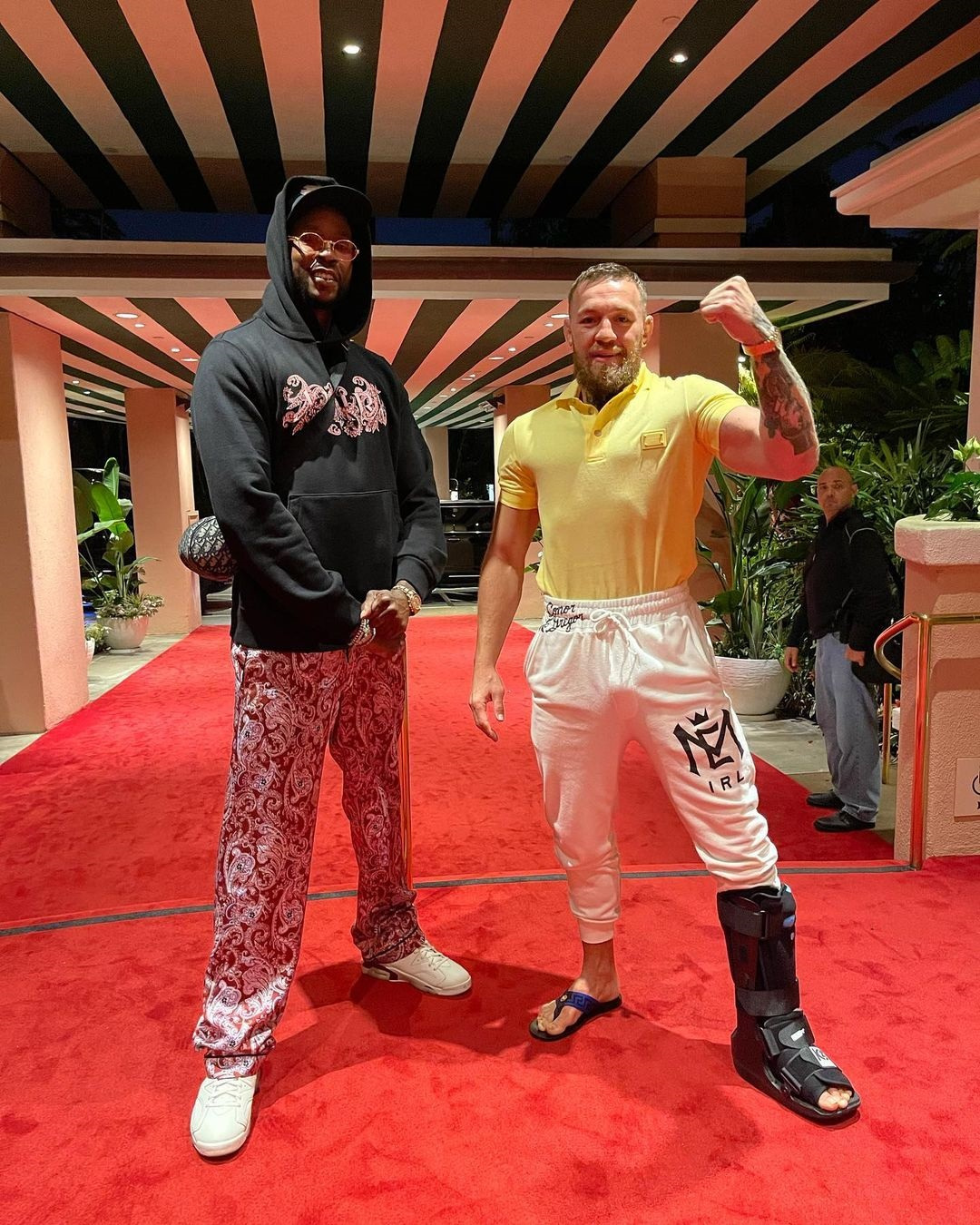 Conor McGregor and 2 Chainz pose with US rapper 2 Chainz, with a surgically-repaired left leg. UFC legend returns to the ring.