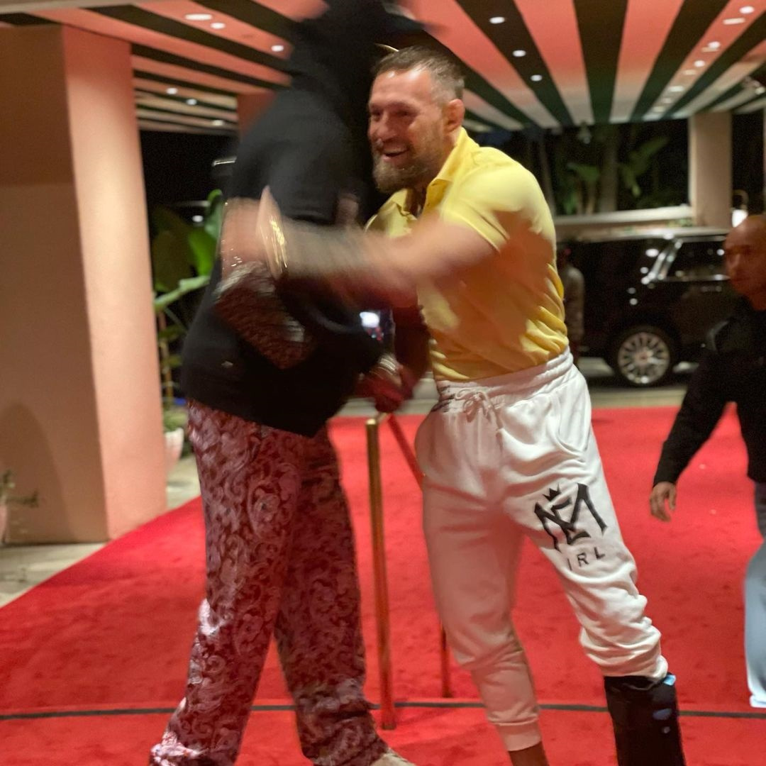 Conor McGregor and 2 Chainz pose with US rapper 2 Chainz, with a surgically-repaired left leg. UFC legend returns to the ring.