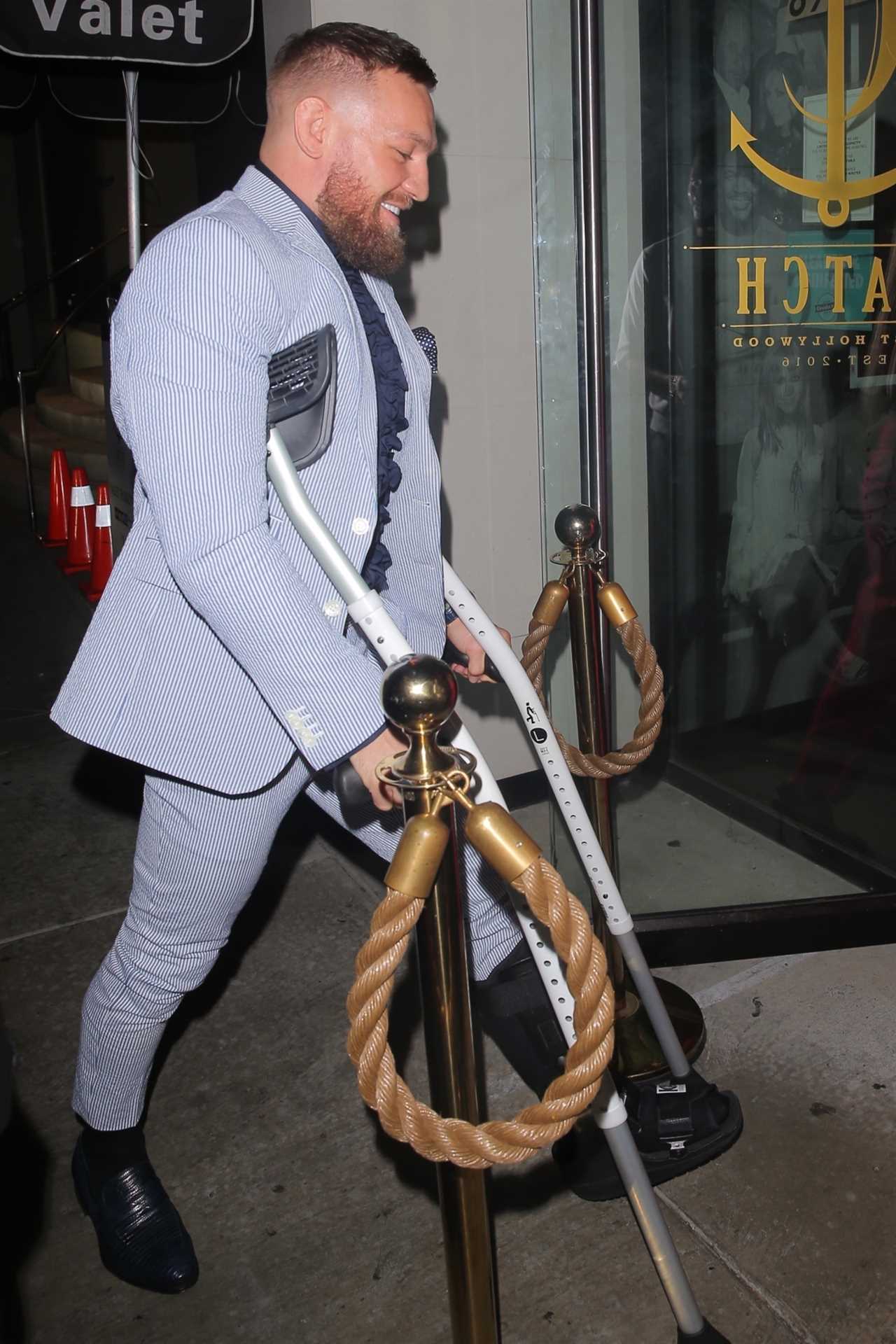 Conor McGregor stumbles into a plush Hollywood restaurant Catch LA as UFC recovers after sustaining a leg injury
