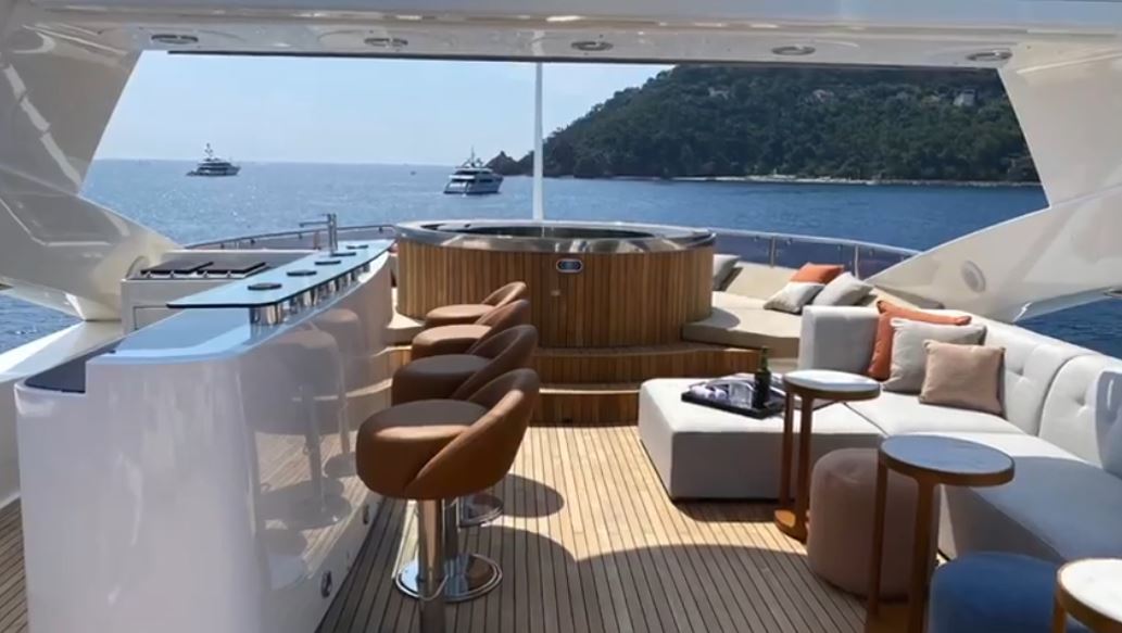 Conor McGregor, UFC fighter, is seated on Conor McGregor's Lamborghini as well as superyachts with pool and floating golf green.