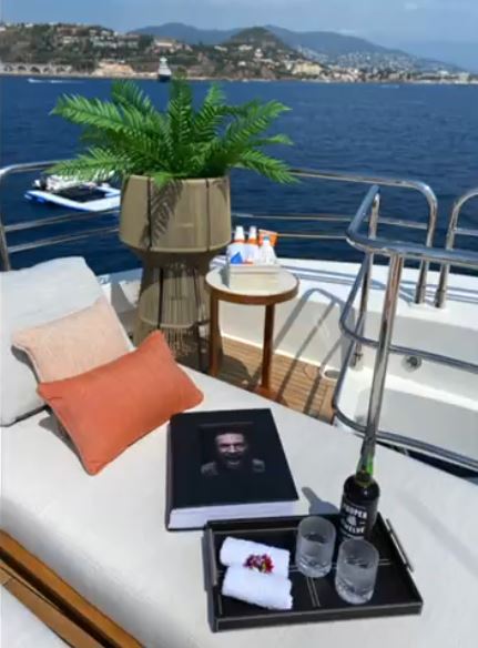 Conor McGregor, UFC fighter, is seated on Conor McGregor's Lamborghini as well as superyachts with pool and floating golf green.