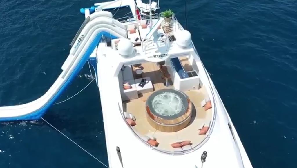 Conor McGregor, UFC fighter, is seated on Conor McGregor's Lamborghini as well as superyachts with pool and floating golf green.