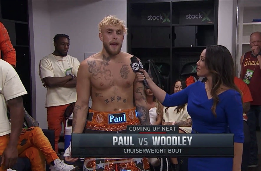 Jake Paul displays ELECTRONIC shorts during a visit by Dustin Poirier, UFC star, backstage at the Tyron Woodley fight