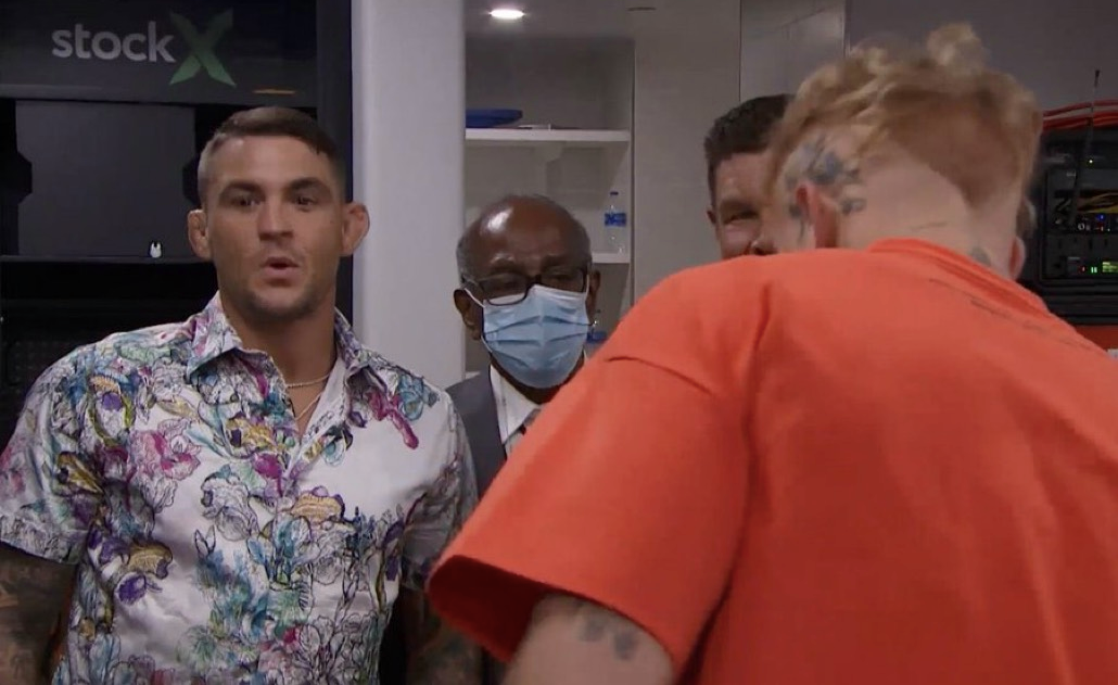 Jake Paul displays ELECTRONIC shorts during a visit by Dustin Poirier, UFC star, backstage at the Tyron Woodley fight