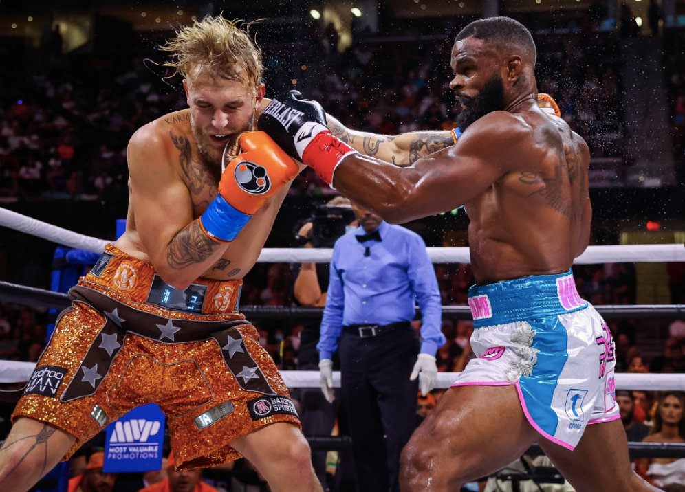 After overcoming the KO scare, Jake Paul wins his biggest pro boxing win with a split-decision victory over former UFC champ Tyron Woodley