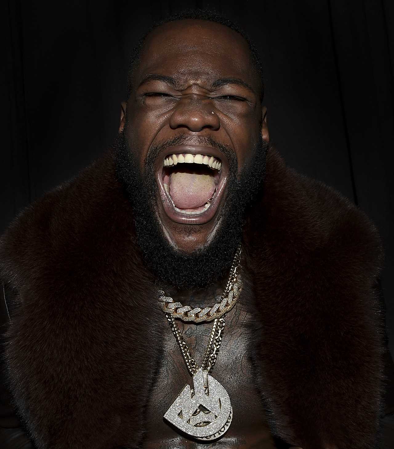Deontay Wilder and Tyson Fury face off in fashion with custom suits, gold slippers, and diamond jewellery
