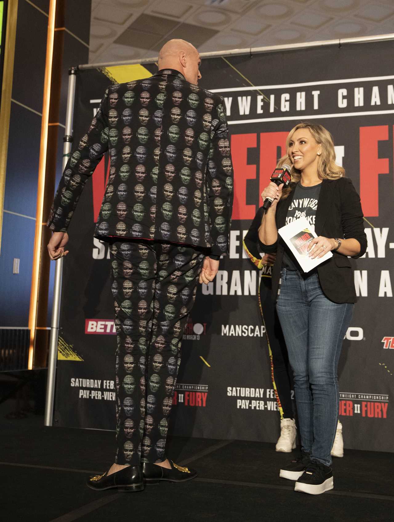 Deontay Wilder and Tyson Fury face off in fashion with custom suits, gold slippers, and diamond jewellery