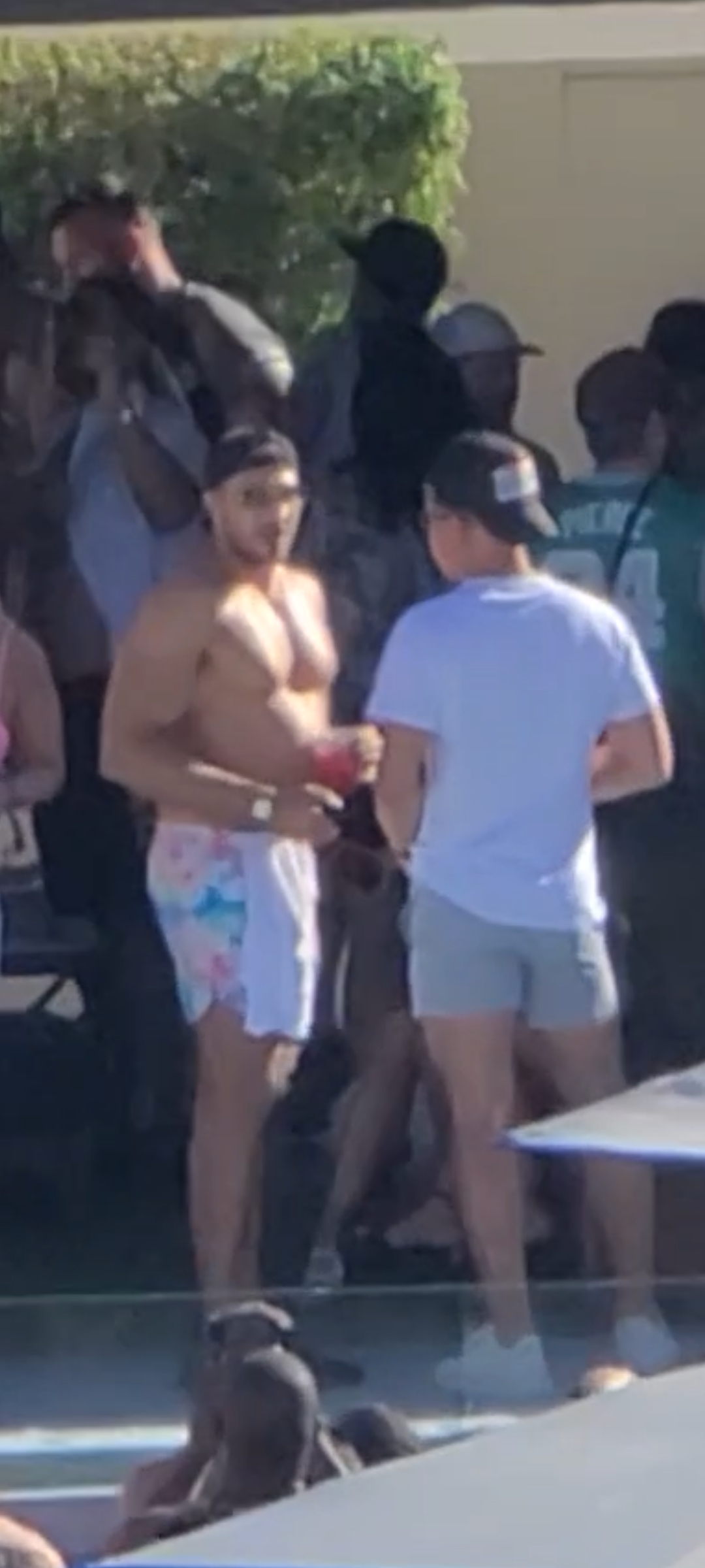Tyson Fury enjoys a pool party with his wife Paris, brother Tommy, and friends while he displays the scars of war alongside Deontay Wilder