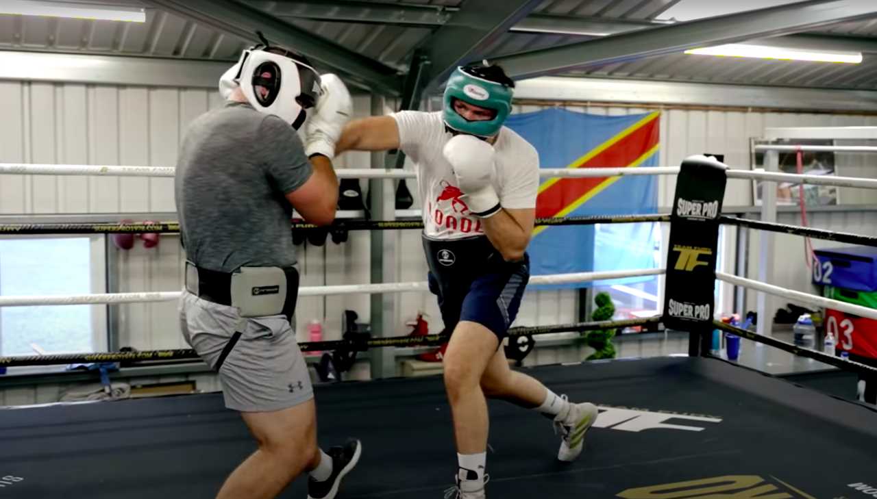 Tyson Fury's cousin Hughie constructs a personal gym in his back yard, defended by two gigantic Rottweilers before the Hammer fight