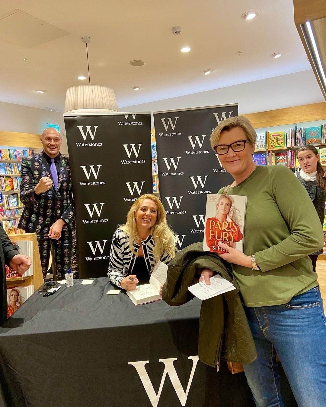 Tyson Fury's suit is covered up with his face while attending the Paris book launch by his wife at Trafford Centre