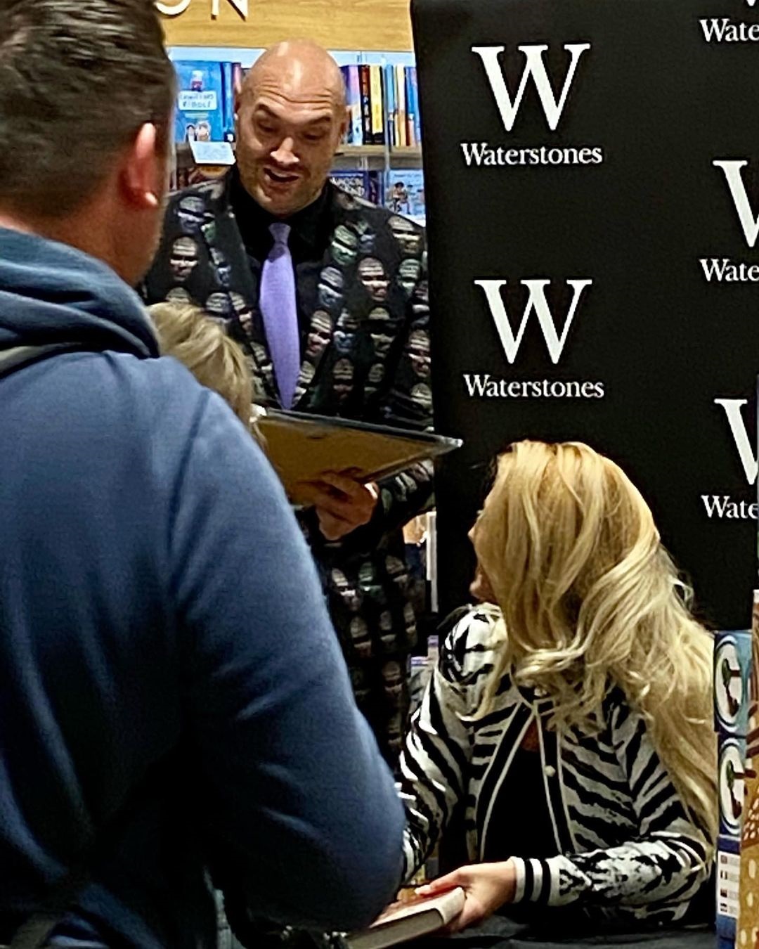 Tyson Fury's suit is covered up with his face while attending the Paris book launch by his wife at Trafford Centre