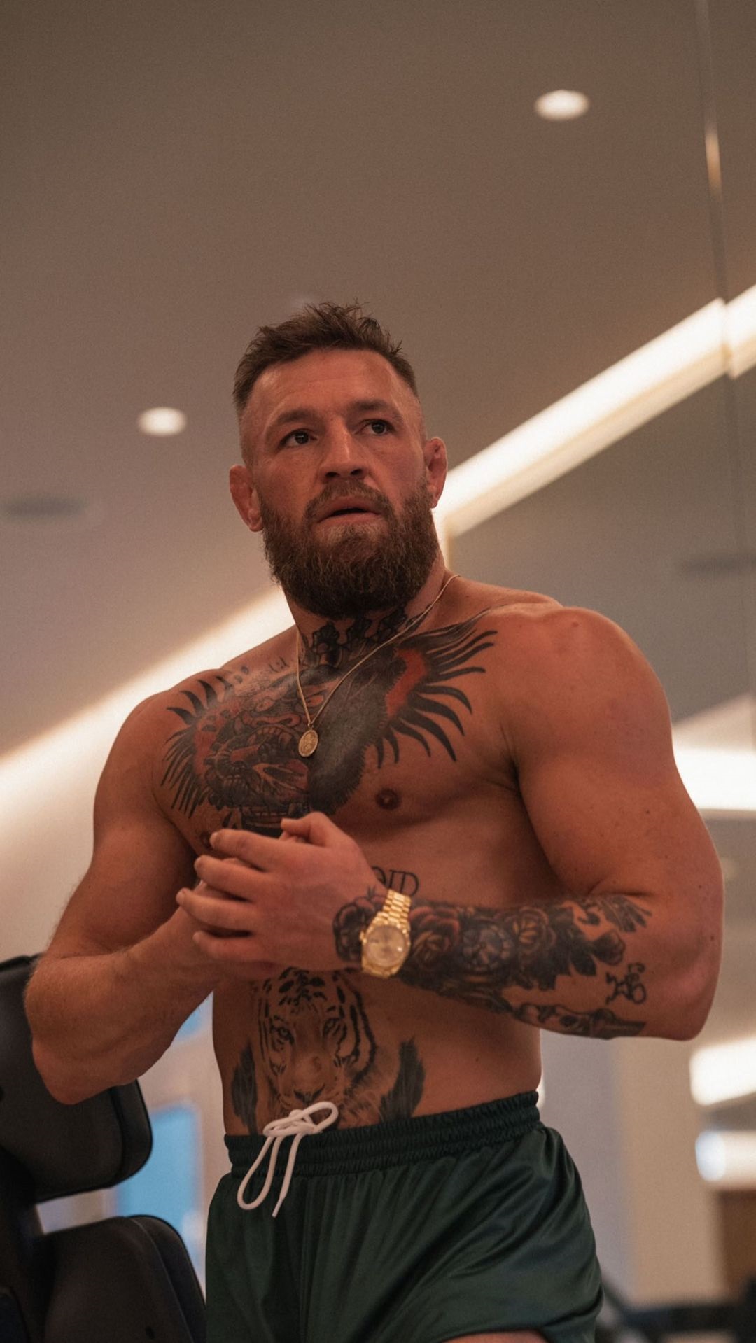 Conor McGregor displays bulging biceps as he bulks up to make a charity fight night appearance at UFC.