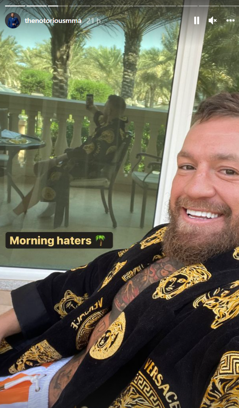 Conor McGregor mocks his 'haters' as he wears a Versace-style Tyson Fury robe before heading to UFC training.