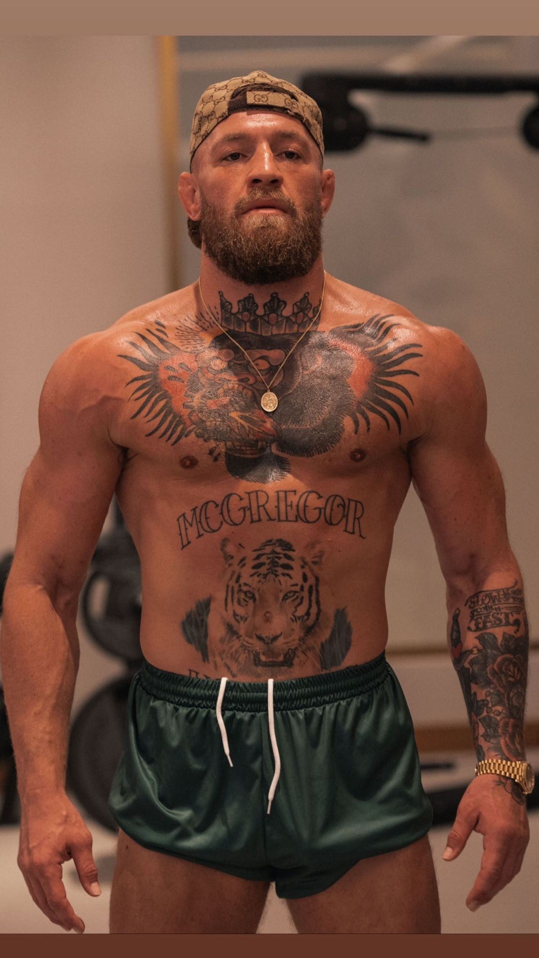 Conor McGregor mocks his 'haters' as he wears a Versace-style Tyson Fury robe before heading to UFC training.