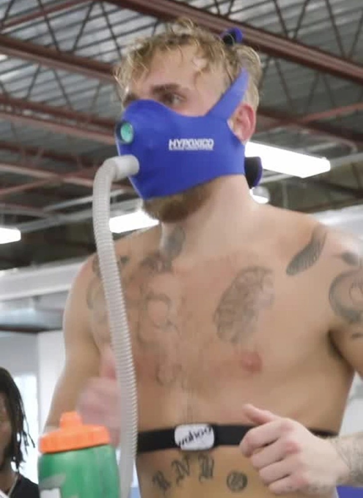 Topless Jake Paul runs in a special altitude training mask while responding to Tyson Fury and Tommy's training video