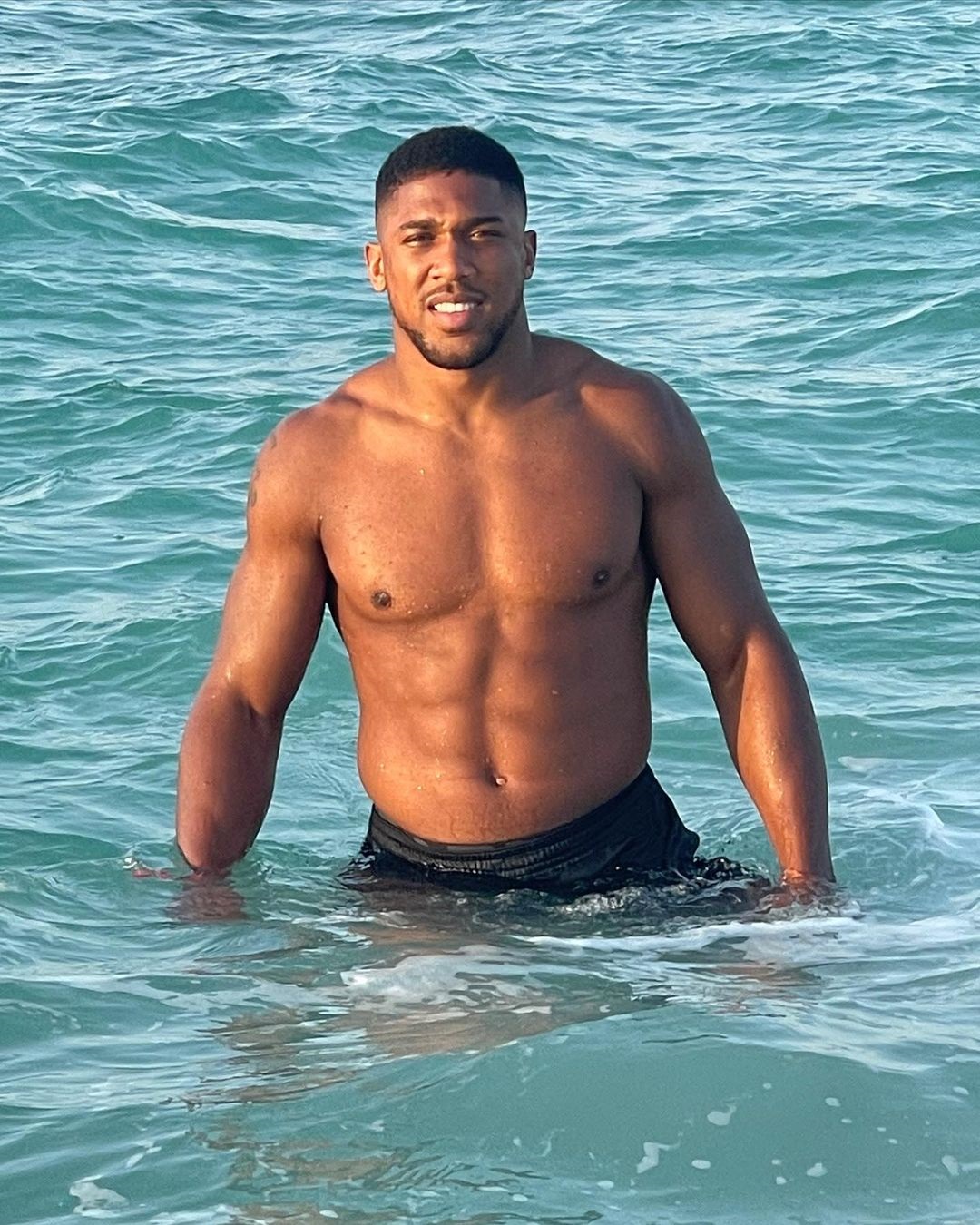Anthony Joshua channeled James Bond's inner James Bond, showing off his bulging muscles in the ocean after refusing Usyk fight.