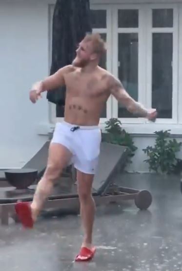Jake Paul dancing in the rain to Olivia Rodrigo, in his only pants, before boarding a private jet for Tyron woodley fight