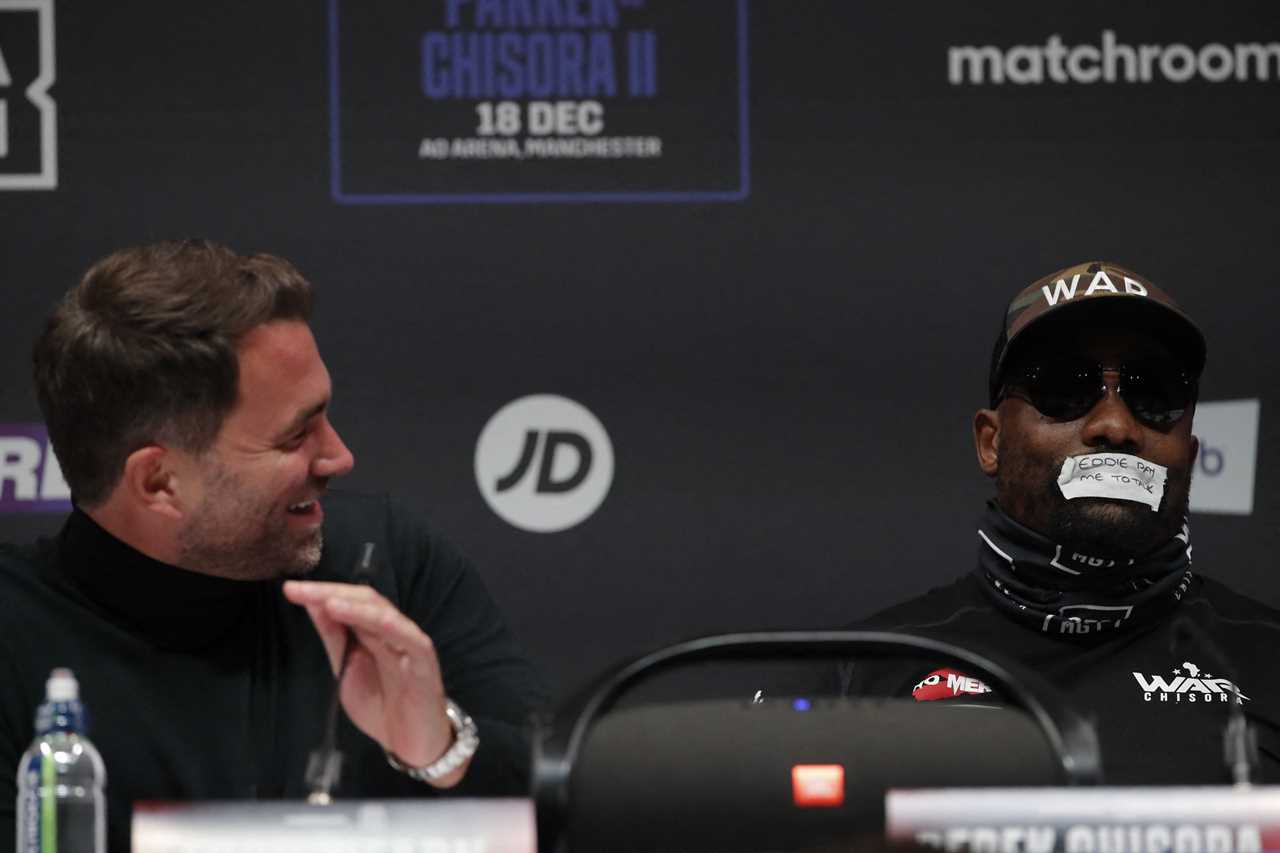 Derek Chisora taps his mouth with a taunting message for Eddie Hearn during a bizarre press conference about Joseph Parker fight