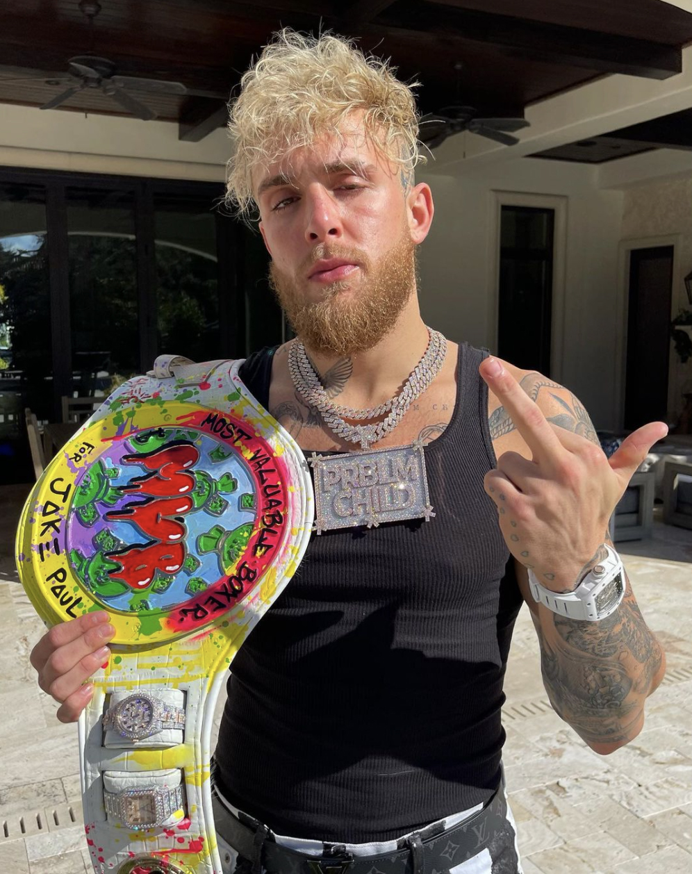 Jake Paul displays custom-made PS350k Most Valuable Boxer belt with Rolex watch in front of Tyron Woodley rematch
