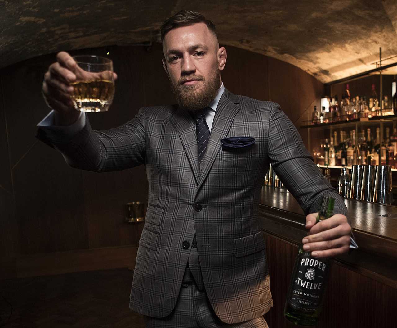 Conor McGregor, UFC legend, reveals his secret stash of Proper 12 whiskey after sustaining a leg injury.