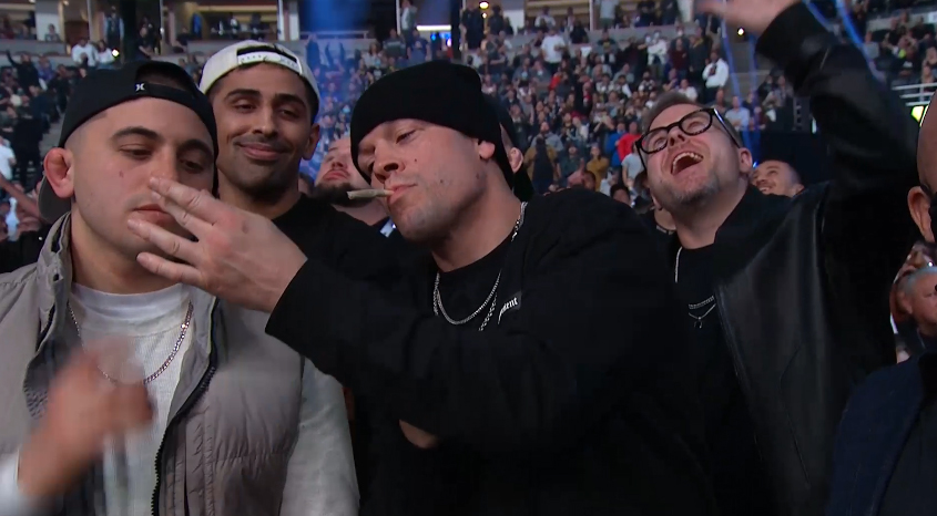 Watch Nate Diaz showcasing his 'joints' live on TV at UFC 270. The camera cuts quickly to Mike Tyson.