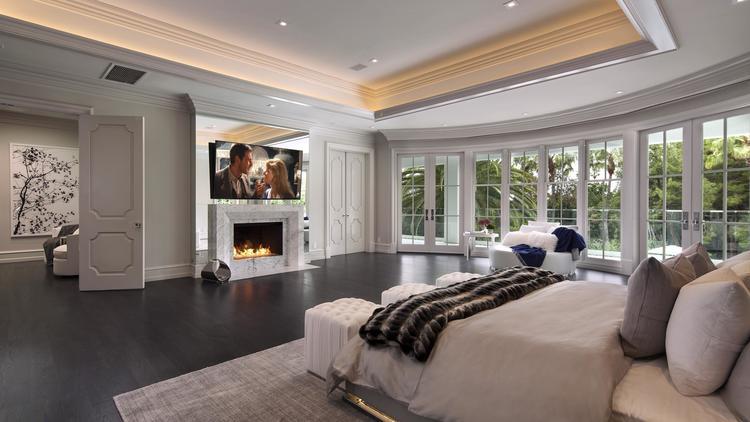 The master bedroom has walk-in wardrobes and private balcony overlooking the garden