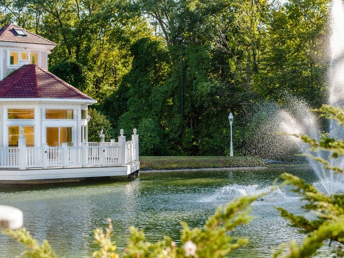 A water feature spouts into the pond