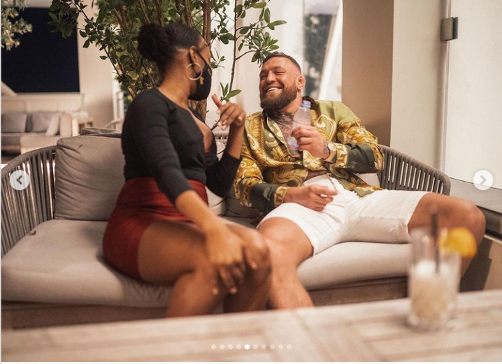 Conor McGregor smiling with a waitress 