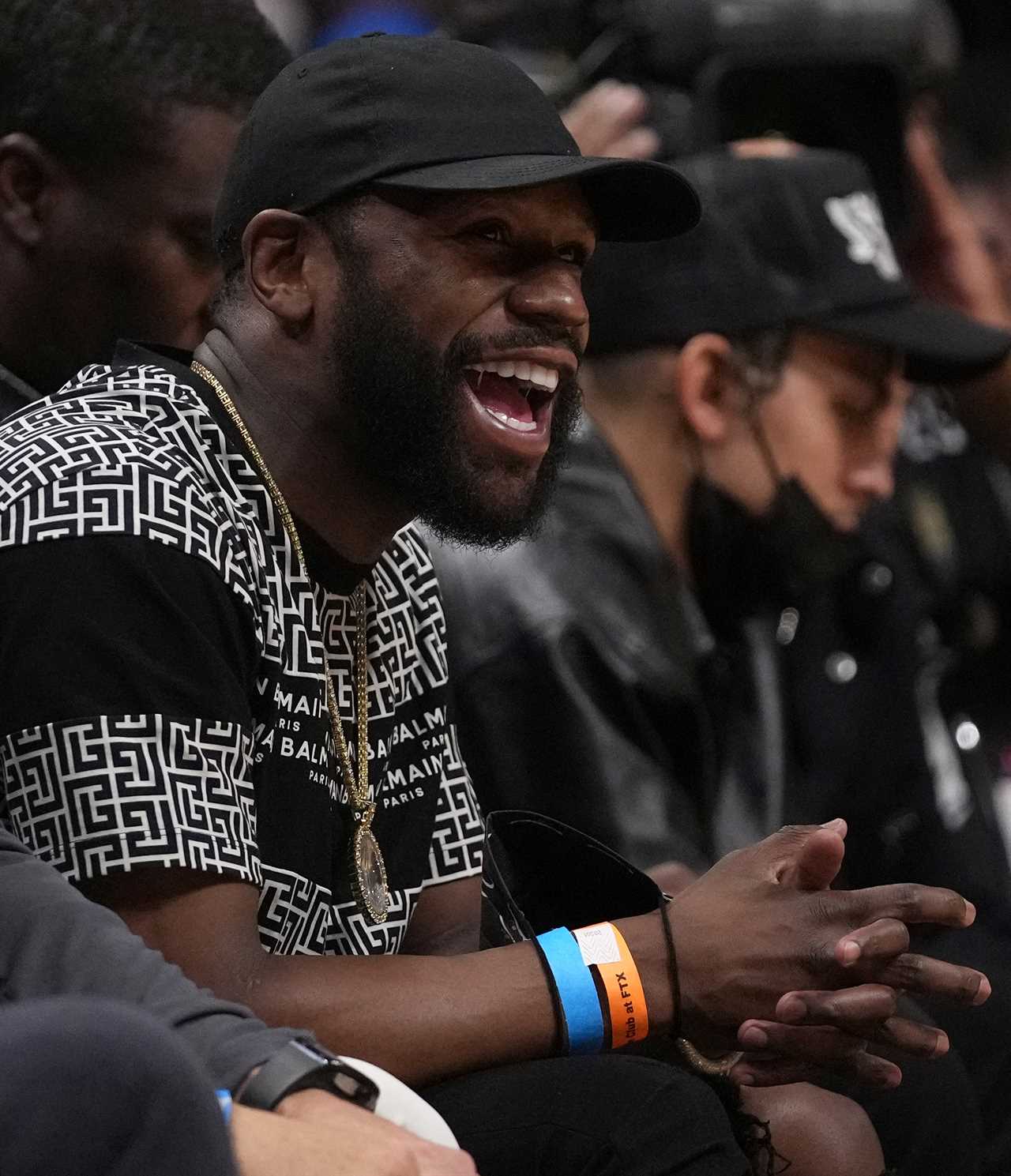 Floyd Mayweather's Balmain boots are so expensive that he wears a matching white and black top. He is a boxing icon who watches NBA