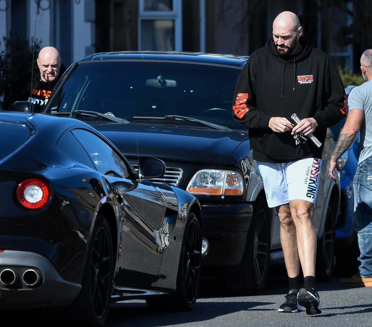 Tyson Fury, 6'9in tall, struggles to get in the supercar before Whyte fight