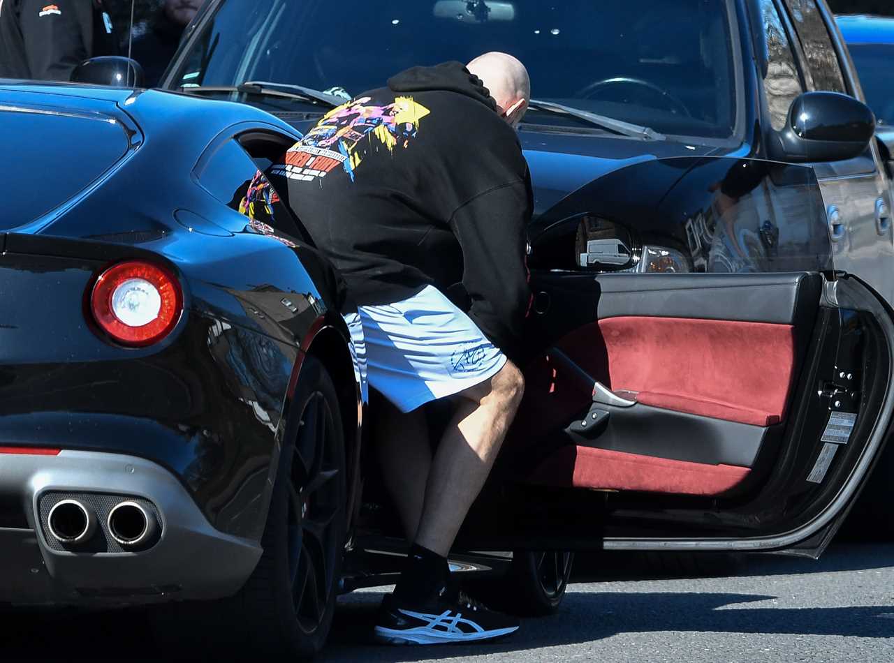 Tyson Fury, 6'9in tall, struggles to get in the supercar before Whyte fight