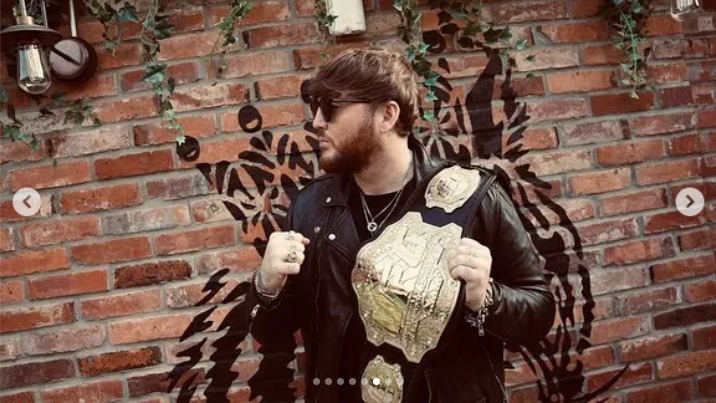 Arthur with a UFC title belt