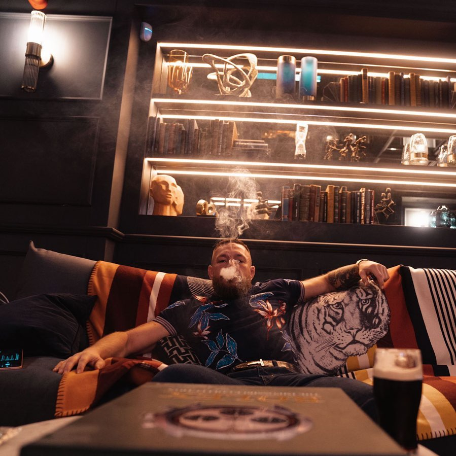 Conor McGregor, UFC star, puffs on a sofa and wishes his fans a 'happy420 day' before the ring returns