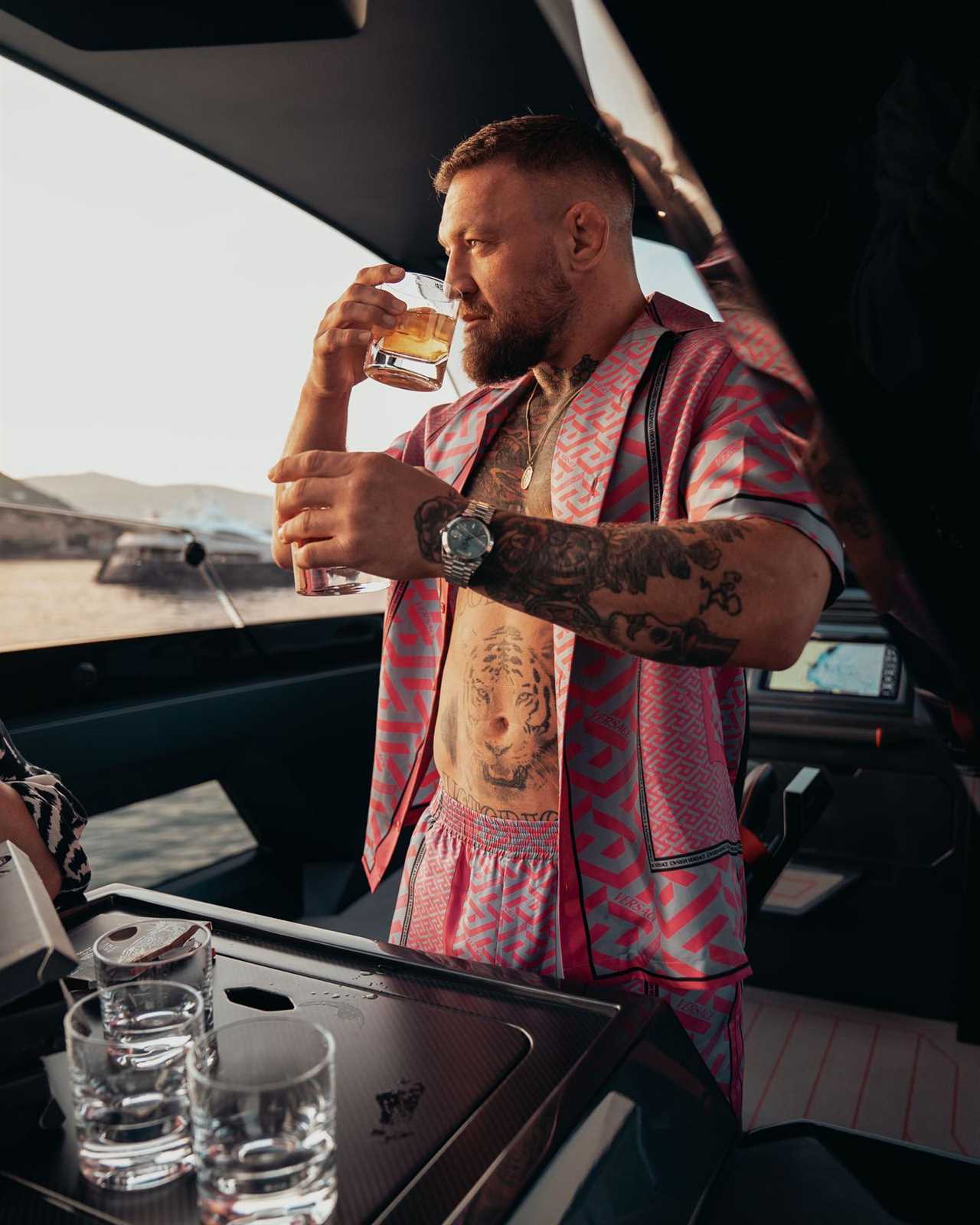 UFC star Conor McGregor enjoys his Proper 12 whiskey after sailing new custom £2.4m Lamborghini yacht while on holiday