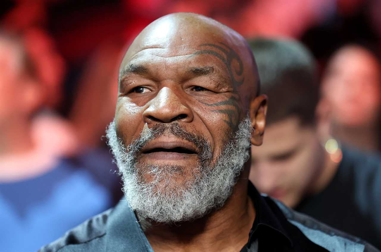 Mike Tyson and Lakiha Tyson smile as they sit ringside to watch Canelo Alvarez lose to Bivol in Las Vegas