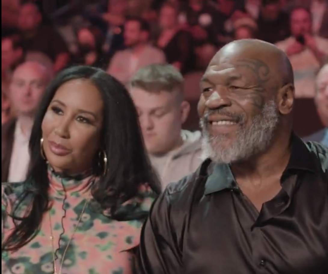Mike Tyson and Lakiha Tyson smile as they sit ringside to watch Canelo Alvarez lose to Bivol in Las Vegas