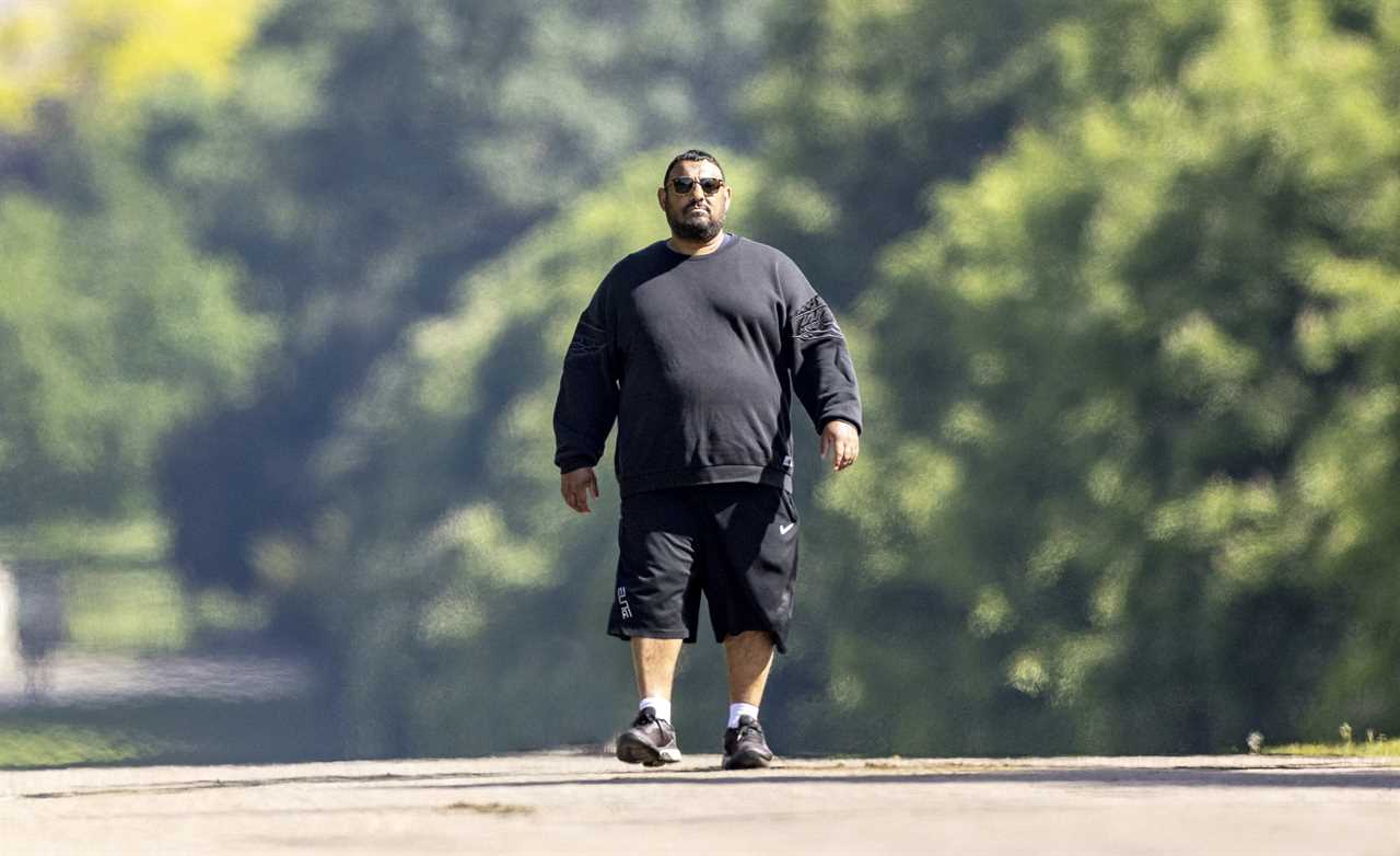 After moving with Queen in Windsor, Prince Naseem Hamed is hard to recognize on a dog walk.