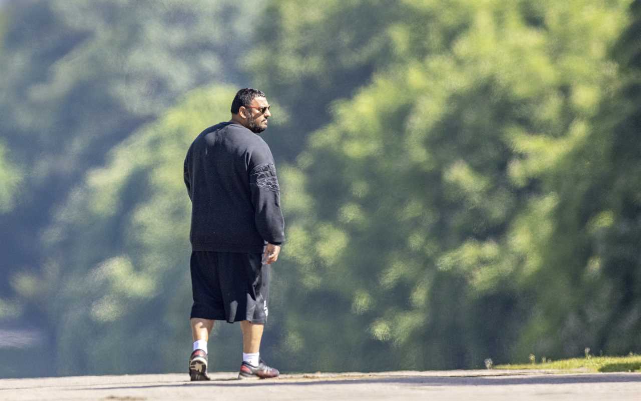 After moving with Queen in Windsor, Prince Naseem Hamed is hard to recognize on a dog walk.