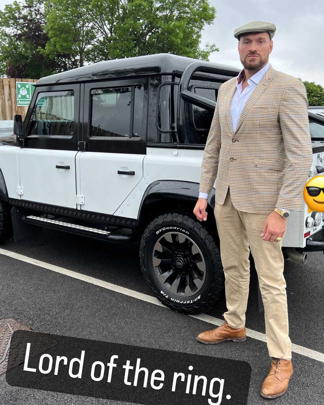 Tyson Fury, 'Lord Of The Ring', is dressed in a suit and boots as he poses beside a luxury jeep while he enjoys retirement