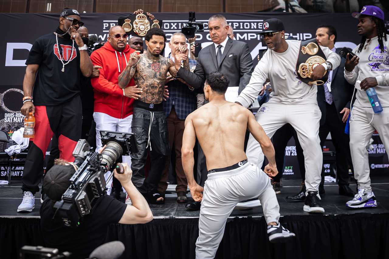 As Mike Tyson's ex coach makes predictions about fights, Gervonta Davies pushes Rolando Romero off the stage during weigh-in.