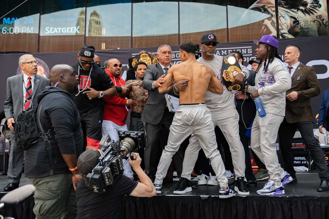 As Mike Tyson's ex coach makes predictions about fights, Gervonta Davies pushes Rolando Romero off the stage during weigh-in.
