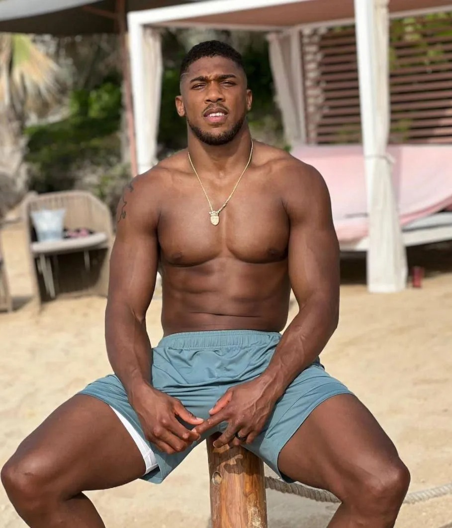 Anthony Joshua looks shredded and ready to fight while sitting on the beach in front of Usyk's rematch