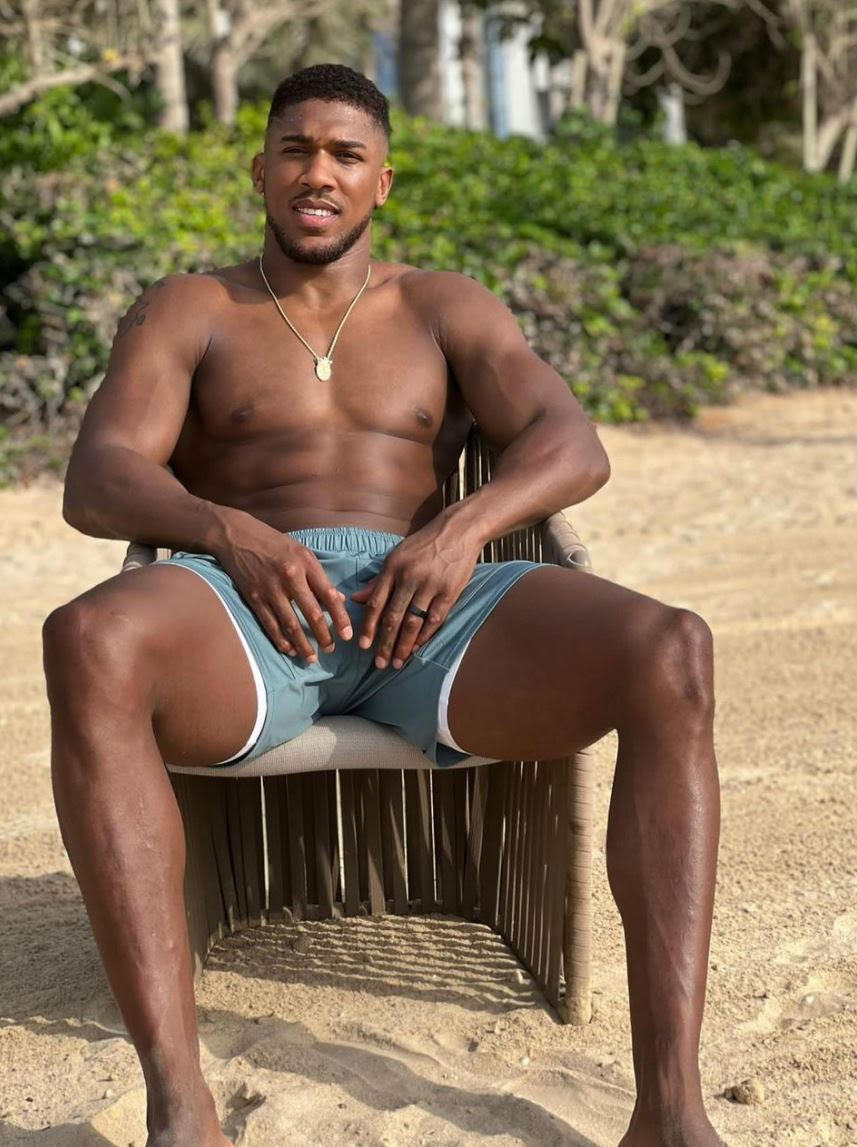 Anthony Joshua looks shredded and ready to fight while sitting on the beach in front of Usyk's rematch