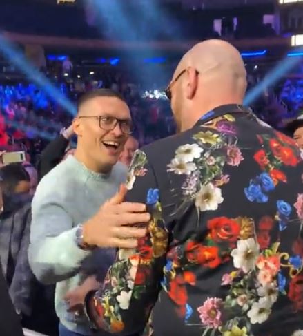 Watch moment Tyson Fury photobombed by undisputed heavyweight title rival Oleksandr Usyk before the pair embrace