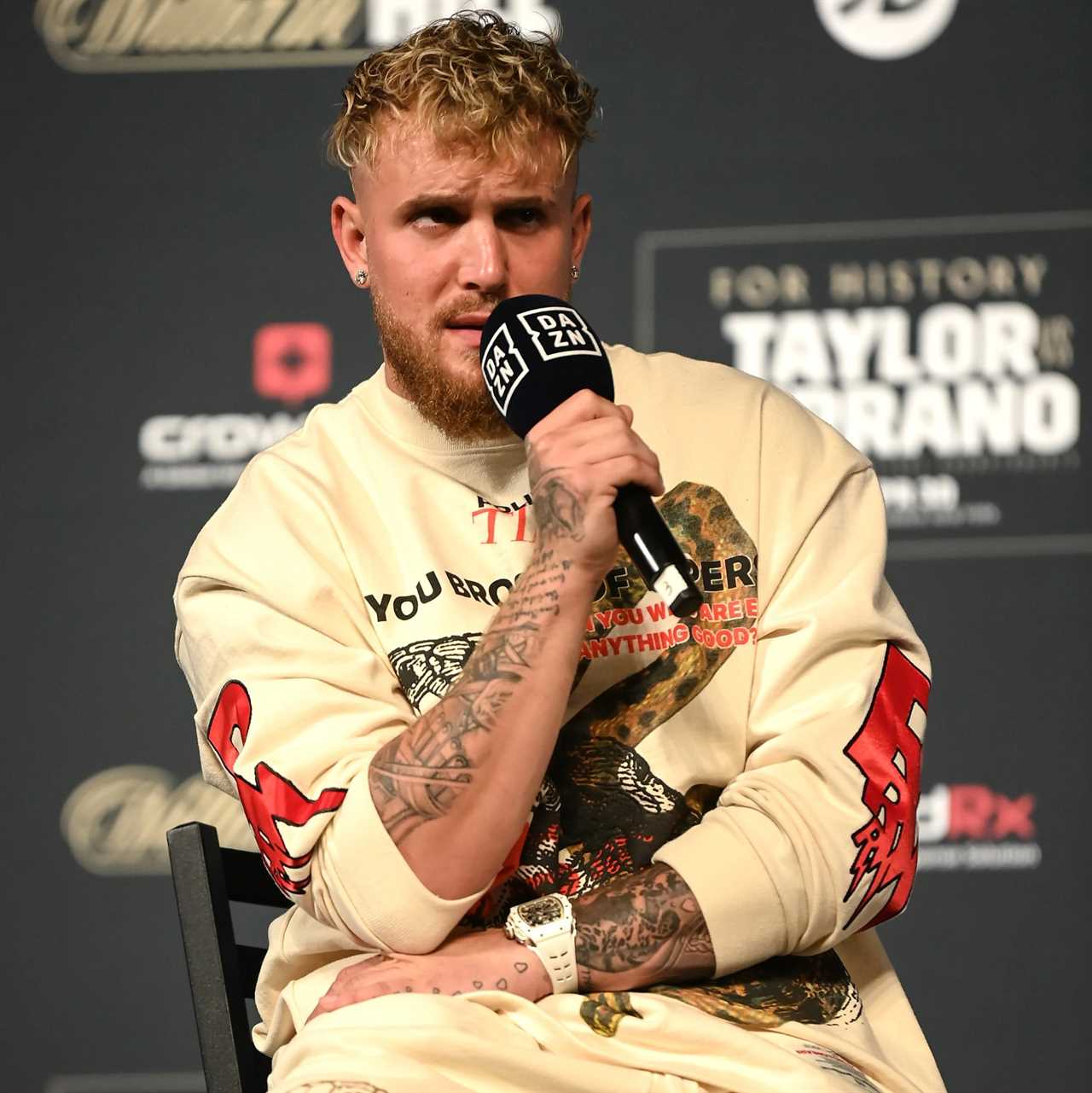 Must Be Jake Paul - Floyd Mayweather cruises with his fans in bright yellow car and matching outfit while he plays his music.