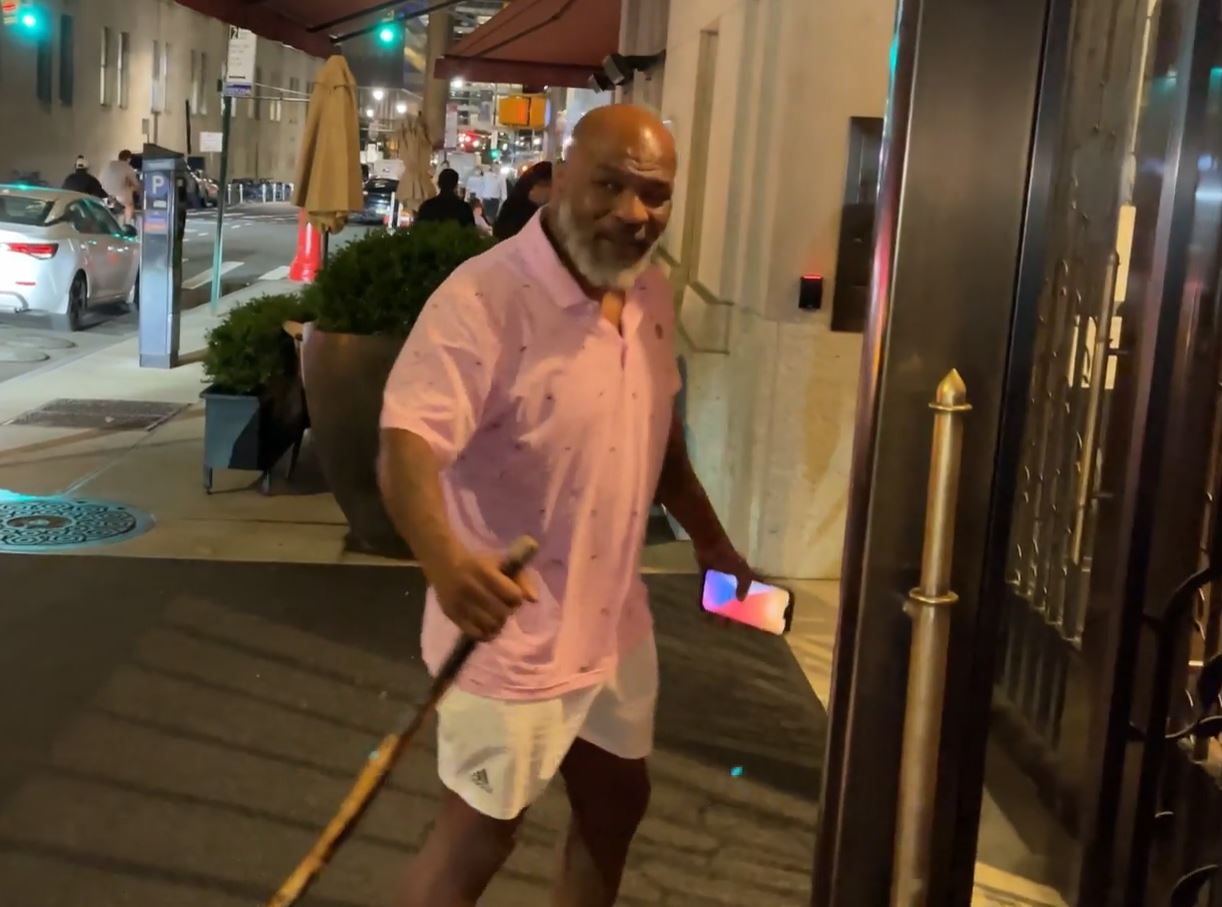 Fearsome Mike Tyson (56), pictured with a walking stick when he arrives at a New York hotel as a former heavyweight champion