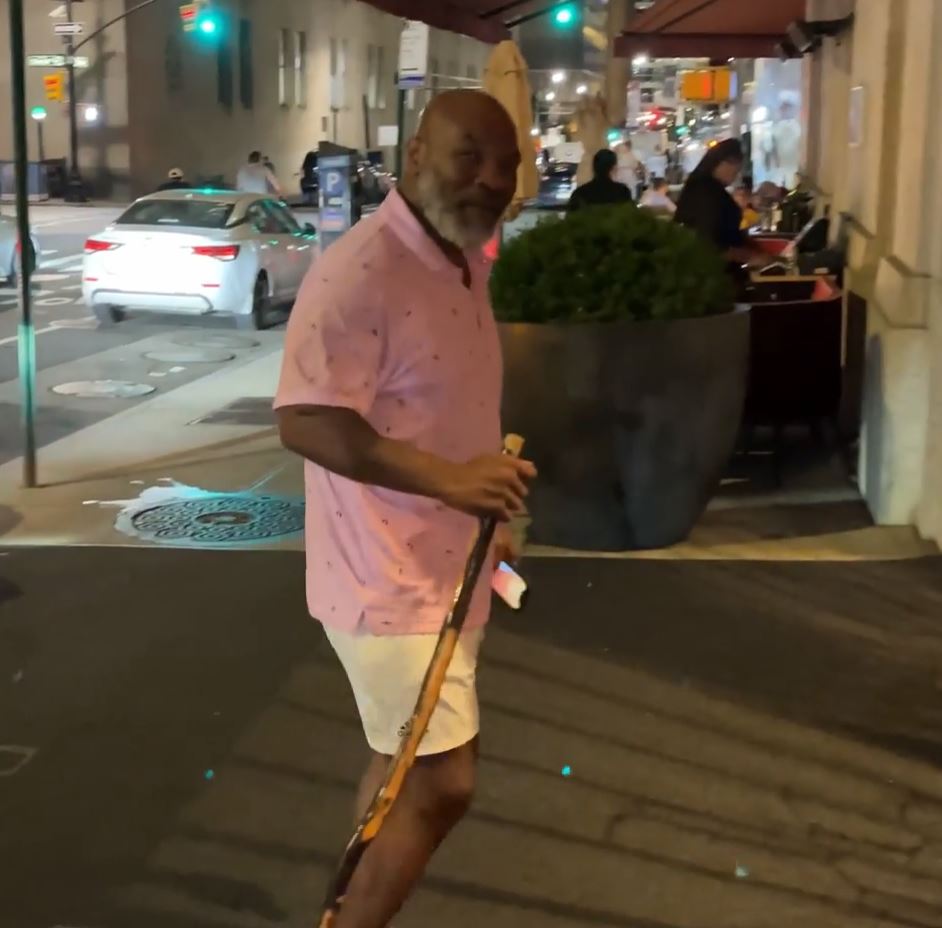 Fearsome Mike Tyson (56), is pictured with a walking stick when he arrives at New York hotel as an ex-heavyweight champion