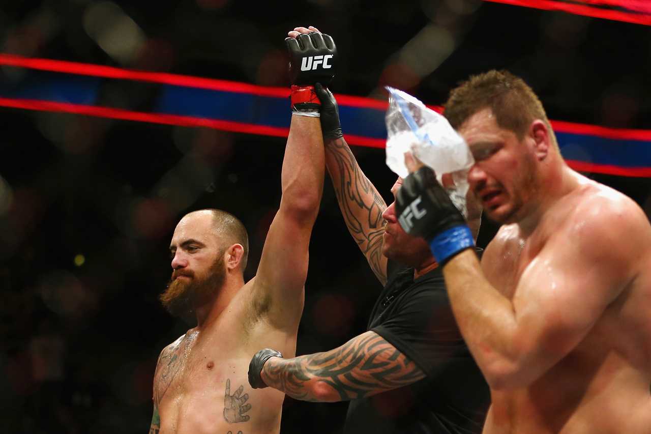 Rousey is currently dating fellow UFC fighter Travis Browne left)
