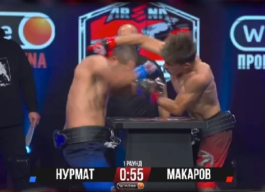 In shocking 'armboxing', defenseless fighters beat each other while holding hands.