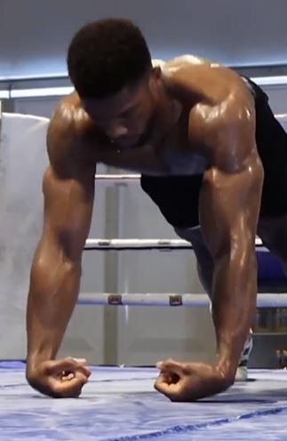 As Anthony Joshua, a henchman, performs a grueling wrist exercise to show off his incredible physique while training for the Usyk fight.